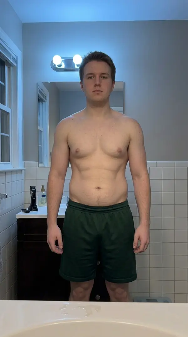 Illustrative sample progress photo of Tyler at week 16, front relaxed pose, with broader shoulders and a tighter waist than in earlier weeks